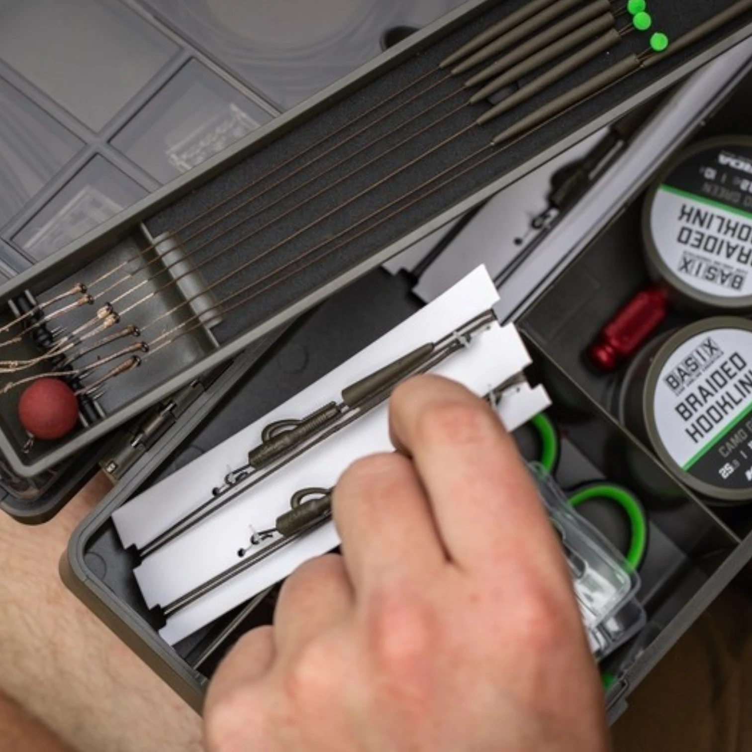 Korda Basix Tackle Box shown in use with rig tools, hooks, swivels and terminal tackle stored inside