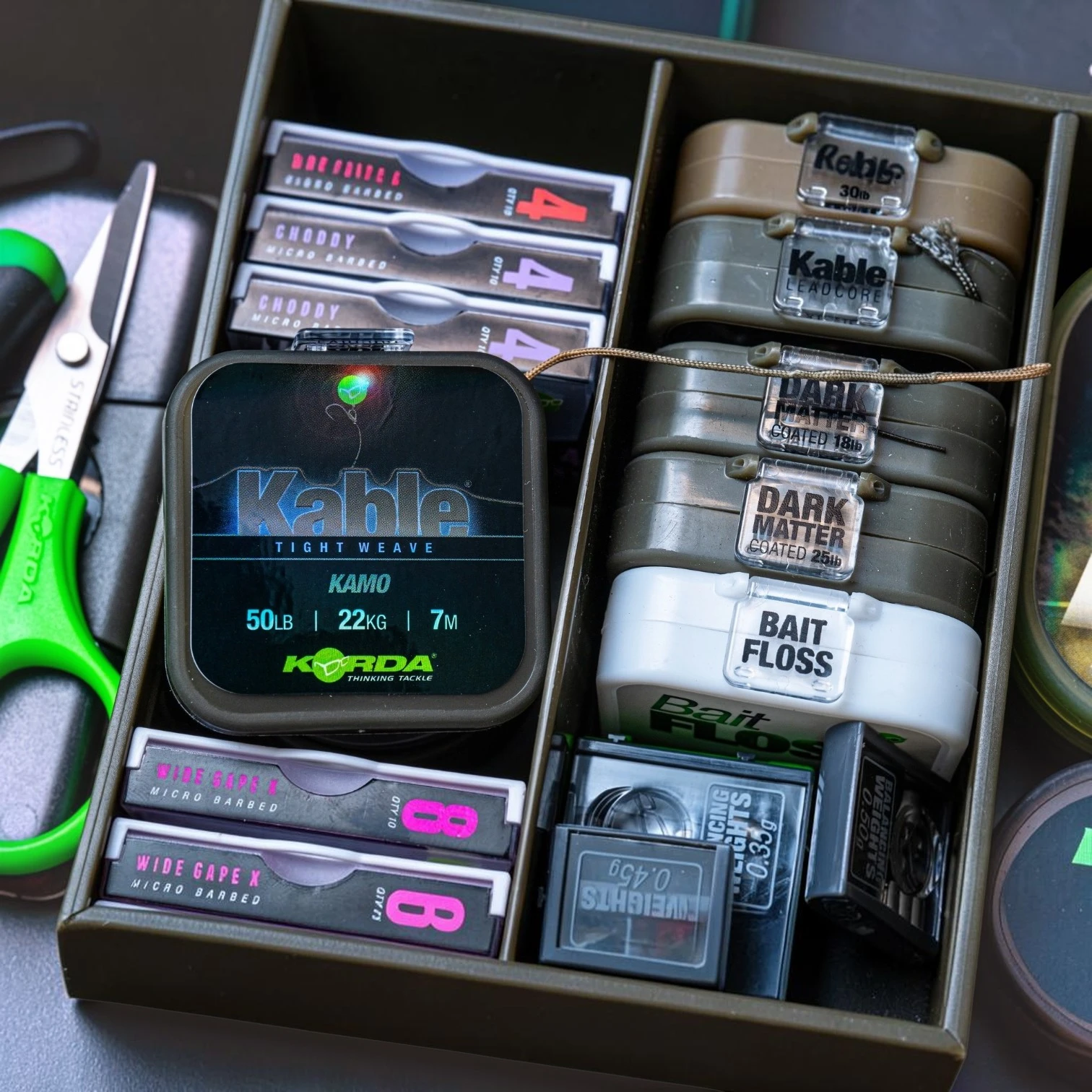 Korda Kable Tight Weave 7m spools shown in tackle box setup demonstrating organised carp fishing leader storage