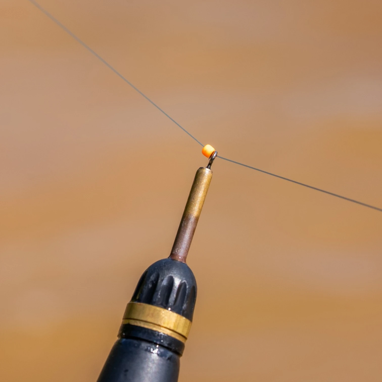 Guru Slider Beads fitted on fishing line showing smooth sliding position between rig components during slider fishing setup