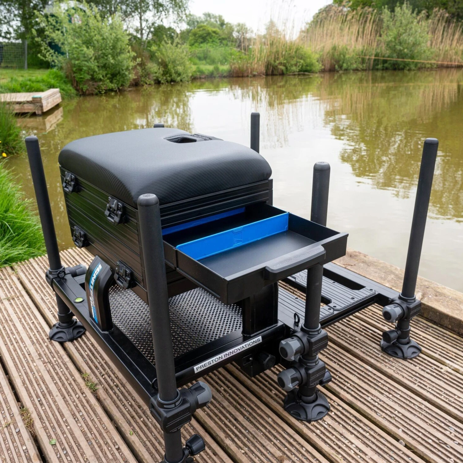 Preston Ignition Station SL Seatbox set up on a fishing peg with the drawers open and tackle organised