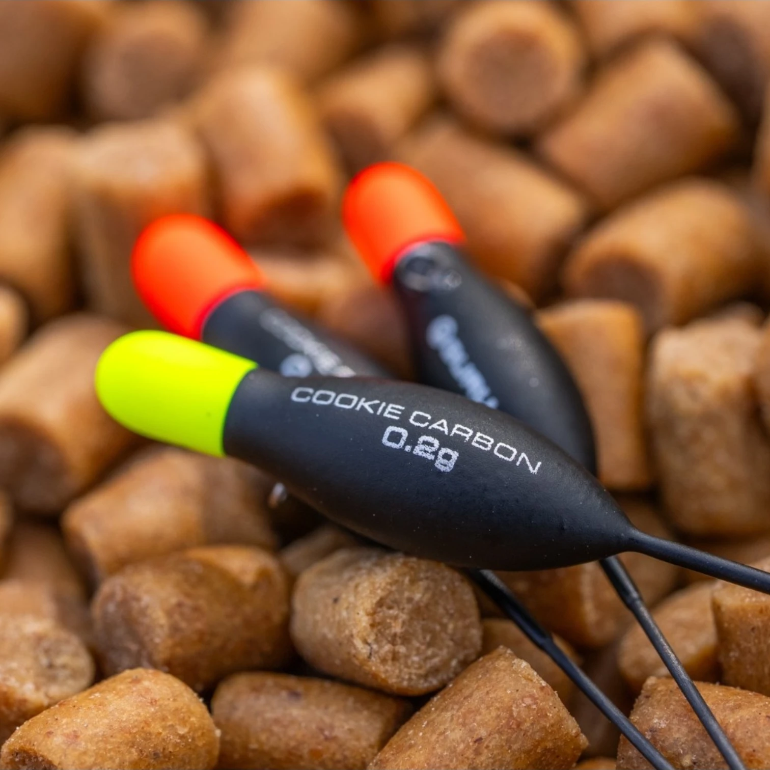 Guru Cookie Carbon Floats laid on fishing pellets
