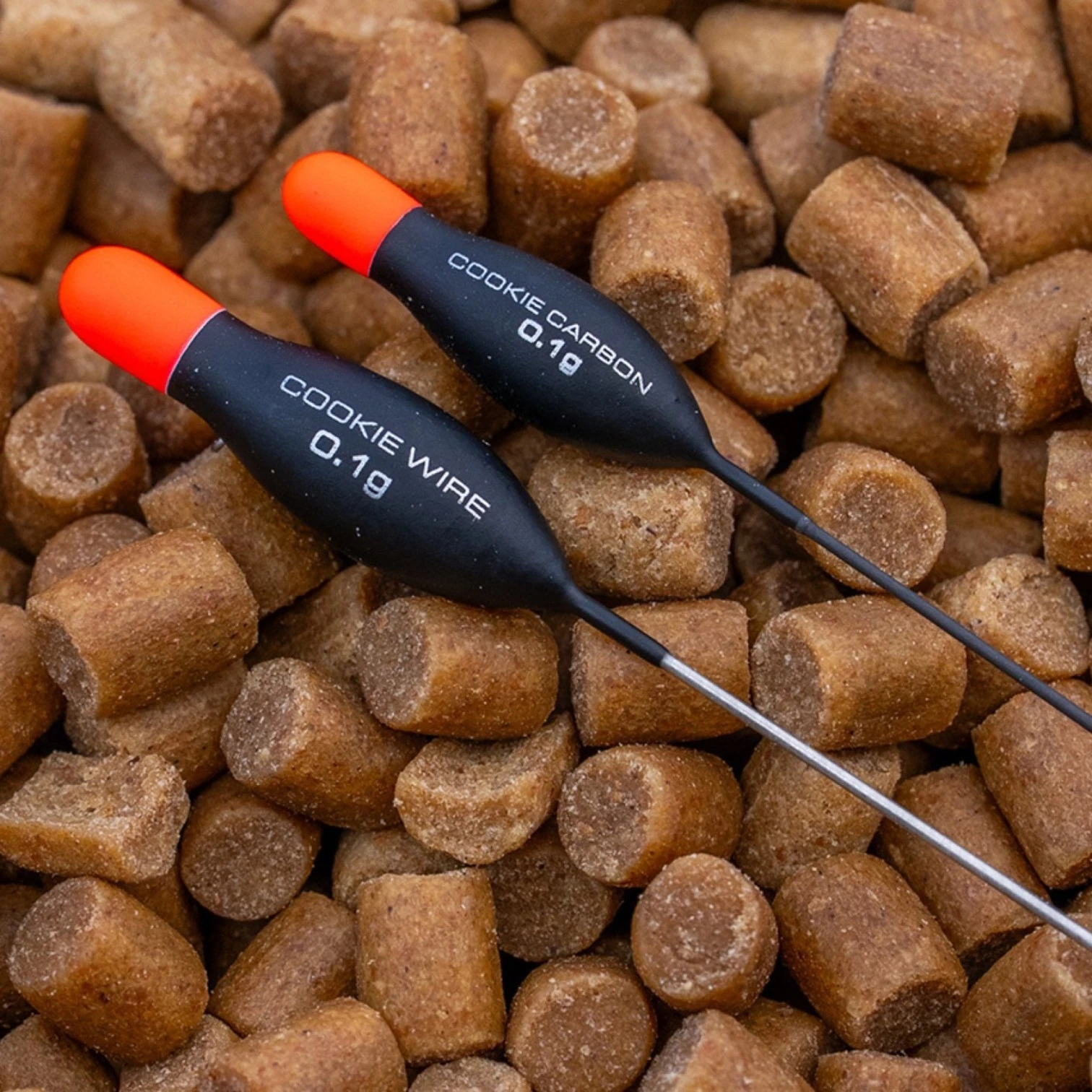 Guru Cookie Wire Pole Floats displayed on top of fishing pellets